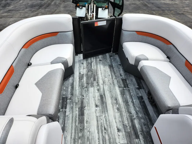 Slide: The Image of 2019 Crest Caliber 230 SL boat interior with gray and white seating and wood-like flooring. - 25
