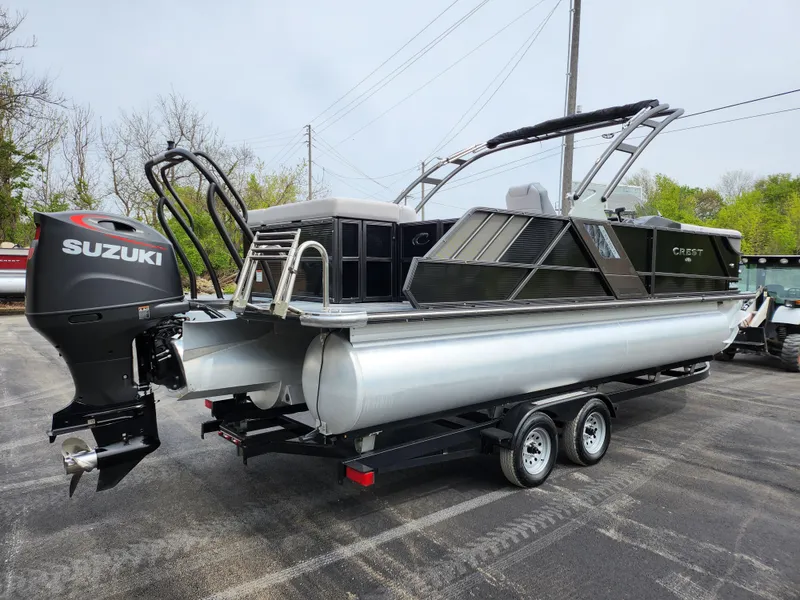 Slide: The Image of 2019 Crest Caliber 230 SL pontoon boat with Suzuki outboard motor on trailer. - 3