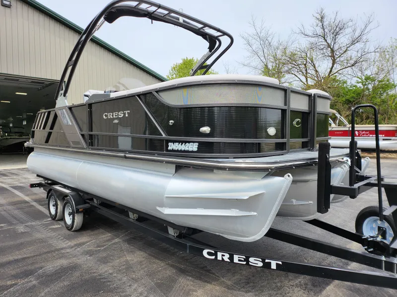 Slide: The Image of 2019 Crest Caliber 230 SL pontoon boat on trailer outside storage facility. - 5