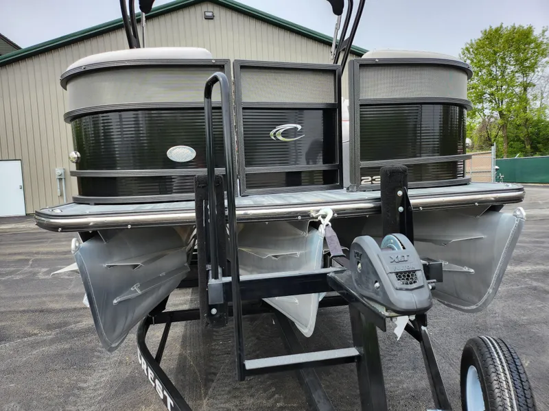 Slide: The Image of 2019 Crest Caliber 230 SL pontoon boat on a trailer, front view. - 6