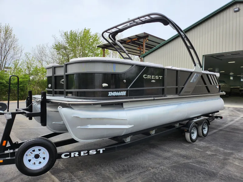 Slide: The Image of 2019 Crest Caliber 230 SL pontoon boat on a trailer outside a storage facility. - 8