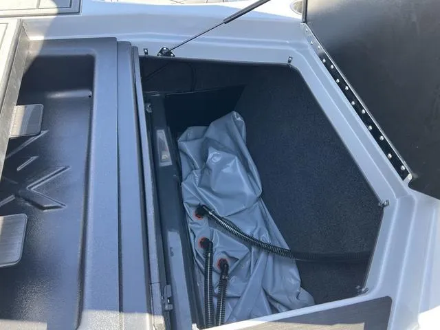Slide: The Image of 2023 ATX Boats 22 TYPE-S storage compartment with hoses and cover. - 14