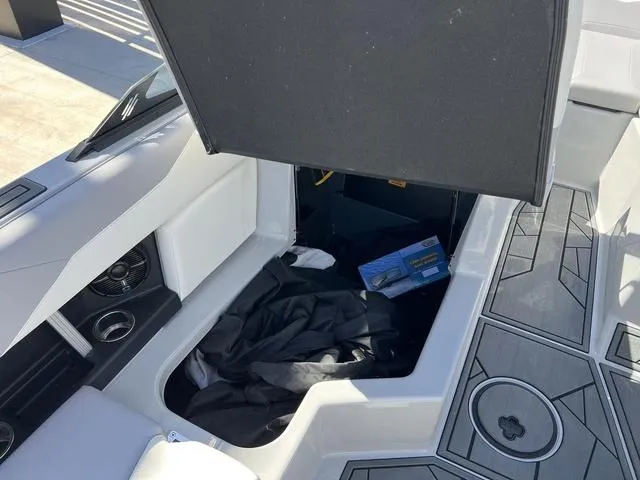 Slide: The Image of 2023 ATX Boats 22 TYPE-S interior storage compartment with open hatch and visible speaker. - 16