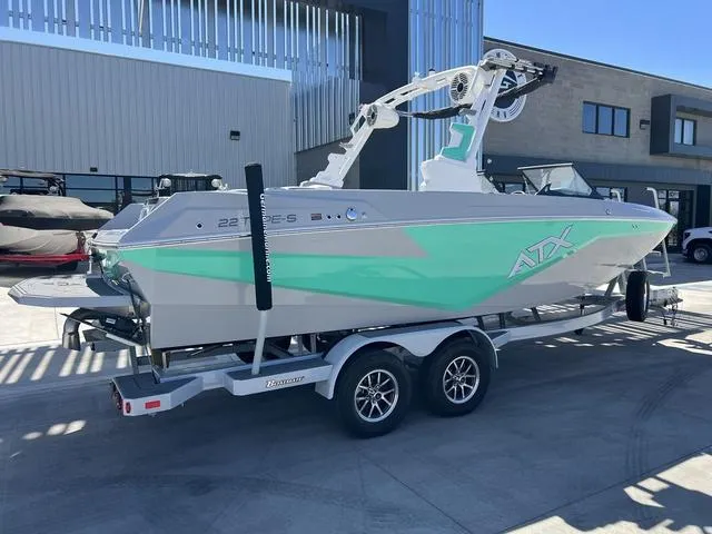 Slide: The Image of 2023 ATX Boats 22 TYPE-S on trailer, mint green and gray design, parked outdoors. - 3