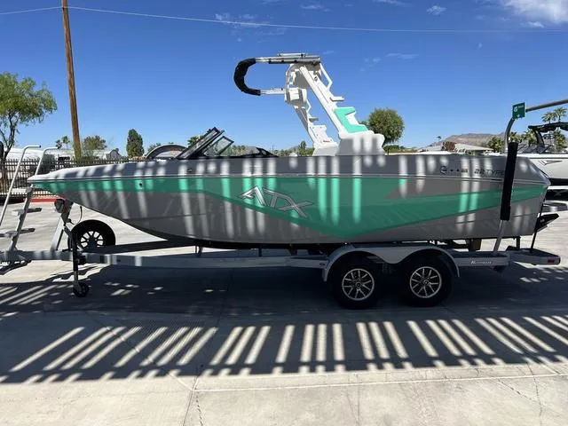 Slide: The Image of 2023 ATX Boats 22 TYPE-S on trailer, side view, teal and gray design. - 6