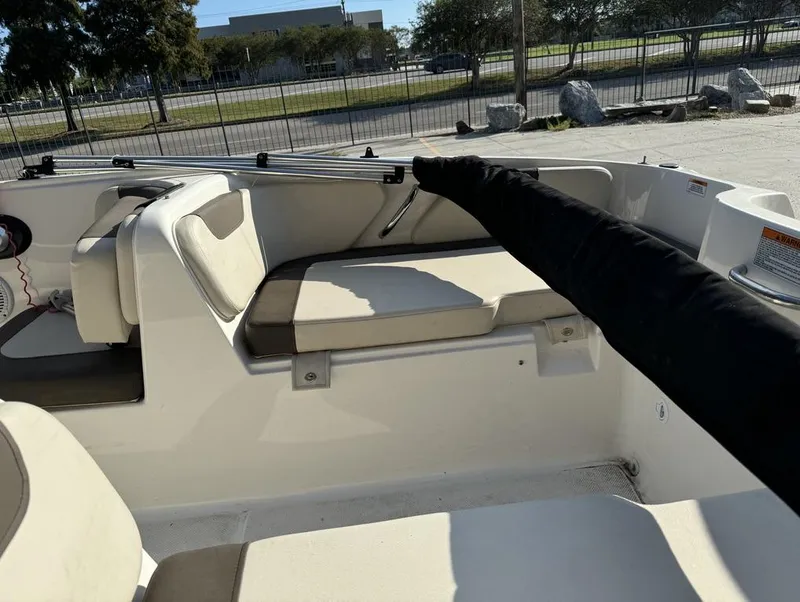 Slide: The Image of 2022 Bayliner Element E18 boat interior with cushioned seating and railing. - 10