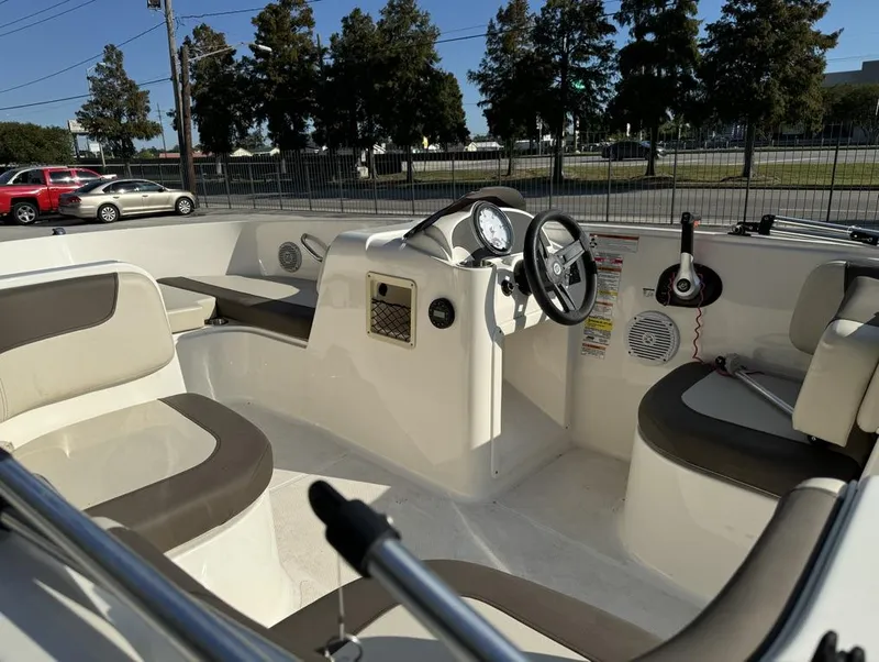 Slide: The Image of 2022 Bayliner Element E18 boat interior with steering wheel and seating. - 16