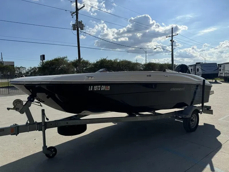 Slide: The Image of 2022 Bayliner Element E18 boat on trailer under blue sky. - 7