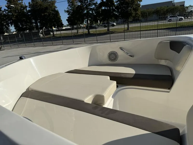Slide: The Image of 2022 Bayliner Element E18 boat interior with cushioned seating and speaker. - 8