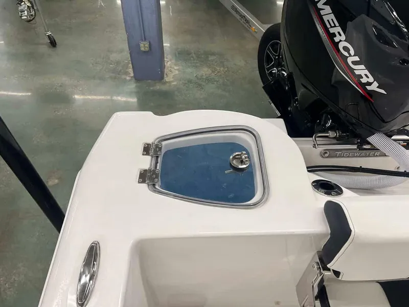 Slide: The Image of 2023 Tidewater 210 Adventure boat with Mercury engine, close-up of rear deck and storage compartment. - 12
