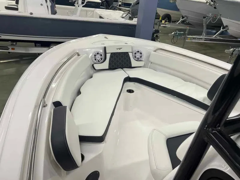 Slide: The Image of 2023 Tidewater 210 Adventure boat interior with cushioned seating and built-in speakers. - 4