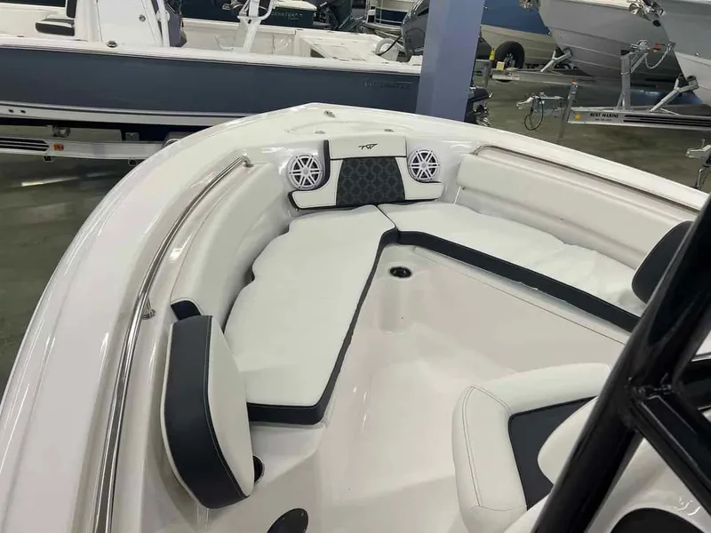 Slide: The Image of 2023 Tidewater 210 Adventure boat interior with cushioned seating and speakers. - 5