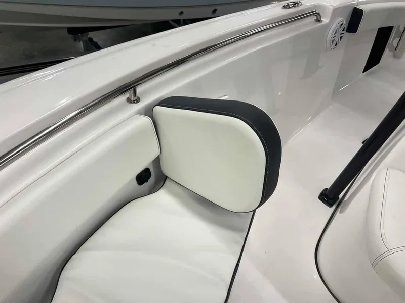 Slide: The Image of 2023 Tidewater 210 Adventure boat interior with white cushioned seating and stainless steel railing. - 6