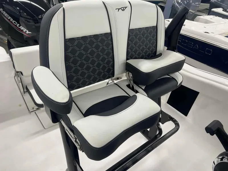 Slide: The Image of 2023 Tidewater 210 Adventure boat seats with armrests and black-and-white upholstery. - 9