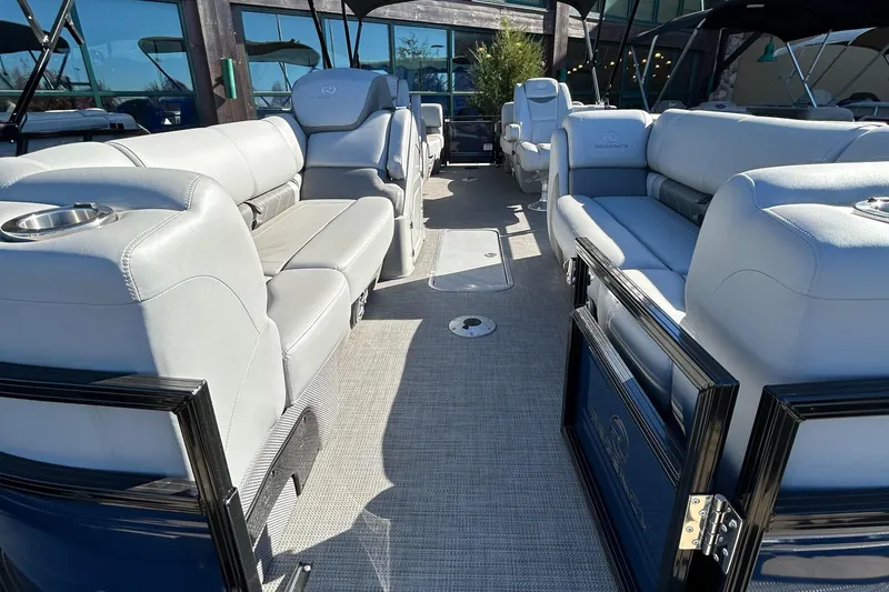 Slide: The Image of 2023 Regency 230 LE3 pontoon boat interior with luxurious seating and modern design. - 2
