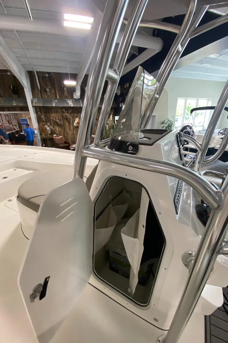 Slide: The Image of 2024 Key West 250 Bay Reef boat interior with open storage compartment. - 20