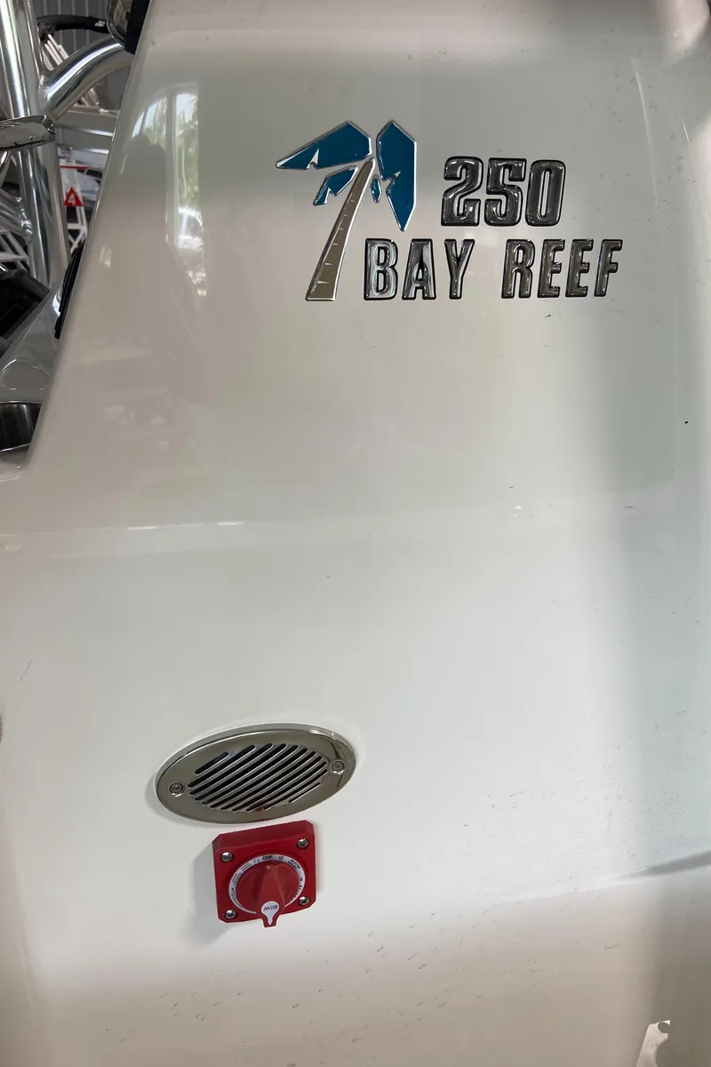 Slide: The Image of 2024 Key West 250 Bay Reef boat exterior with logo and control panel. - 27