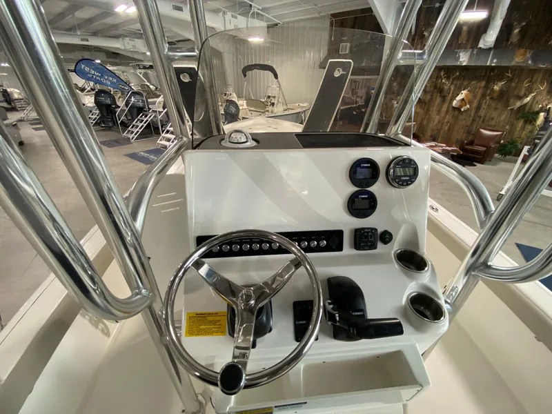 Slide: The Image of 2024 Key West 250 Bay Reef boat console with steering wheel and controls. - 9