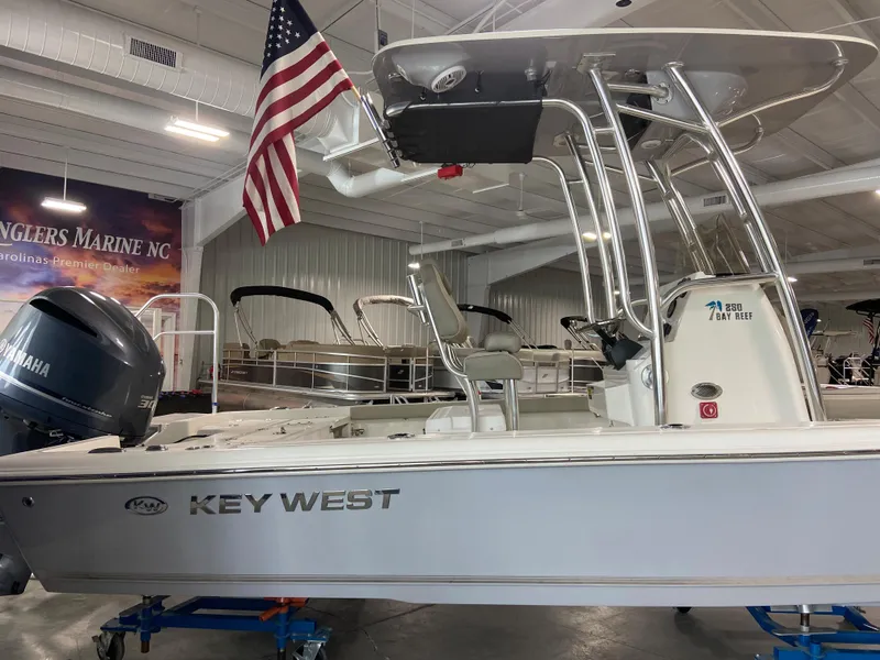 Slide: The Image of 2024 Key West 250 Bay Reef boat displayed indoors with American flag. - 4
