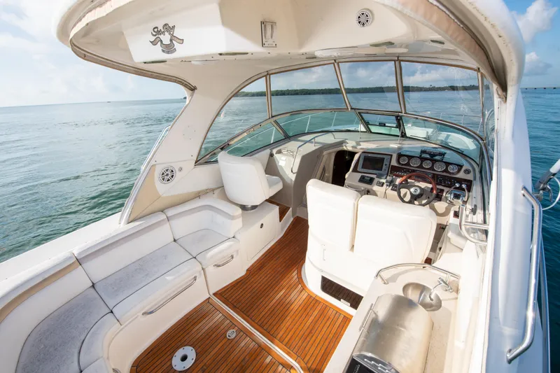 Slide: The Image of 2009 Sea Ray 350 Sundancer boat interior with helm and seating area. - 1