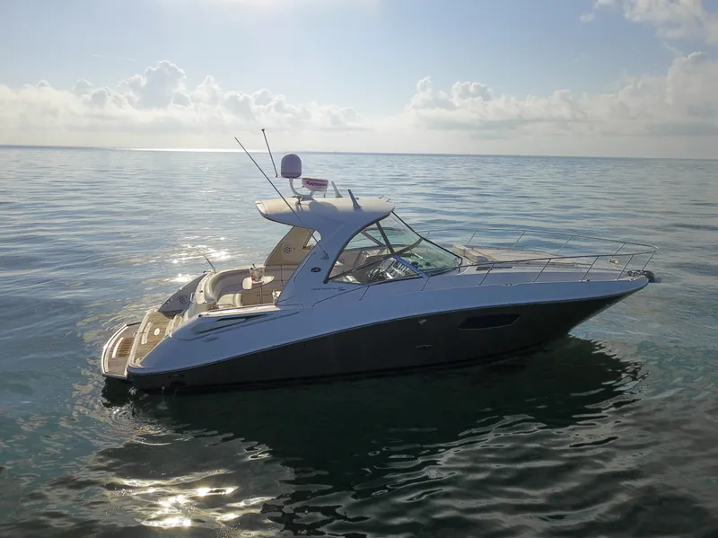 Slide: The Image of 2009 Sea Ray 350 Sundancer yacht on calm ocean waters. - 16