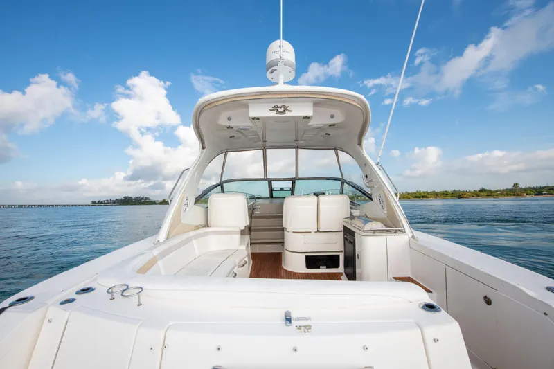 Slide: The Image of 2009 Sea Ray 350 Sundancer boat with spacious deck and seating on calm water. - 19