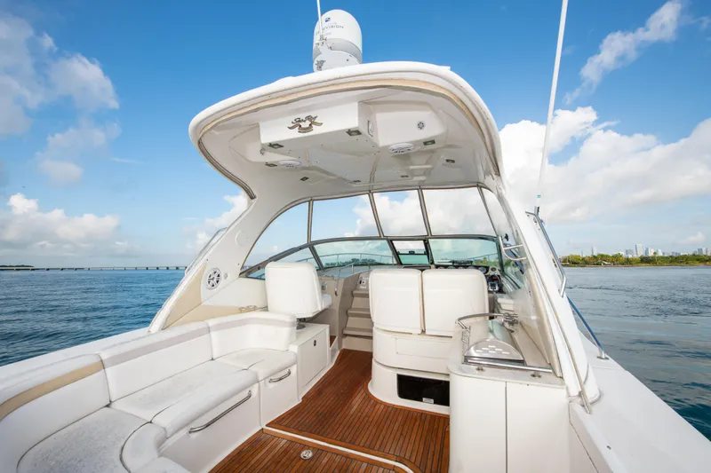 Slide: The Image of 2009 Sea Ray 350 Sundancer boat interior with white seating and wooden flooring. - 20