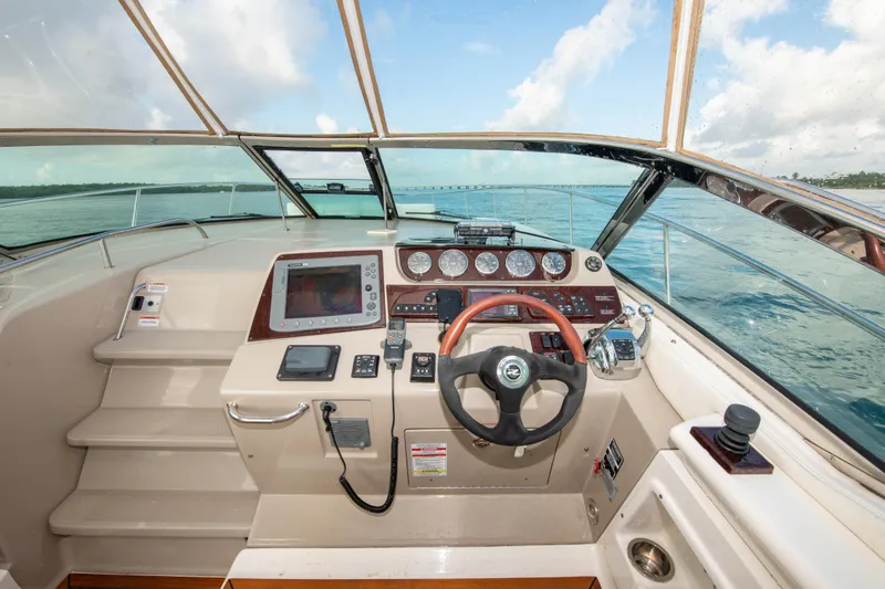 Slide: The Image of 2009 Sea Ray 350 Sundancer helm with navigation equipment and ocean view. - 23