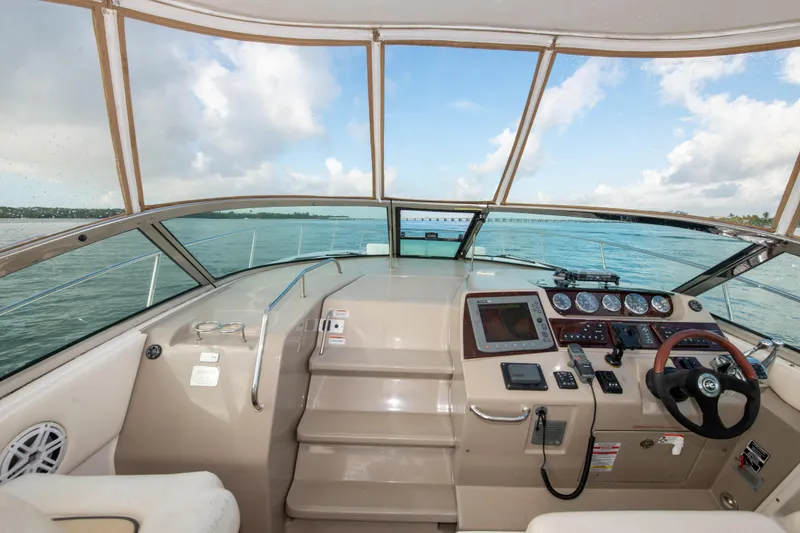 Slide: The Image of 2009 Sea Ray 350 Sundancer helm with navigation instruments and ocean view. - 24