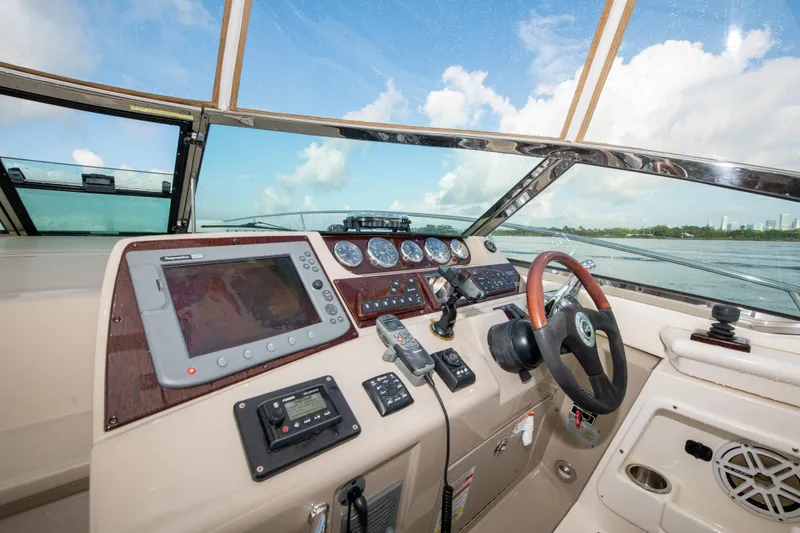 Slide: The Image of Helm of 2009 Sea Ray 350 Sundancer with navigation equipment and steering wheel. - 25