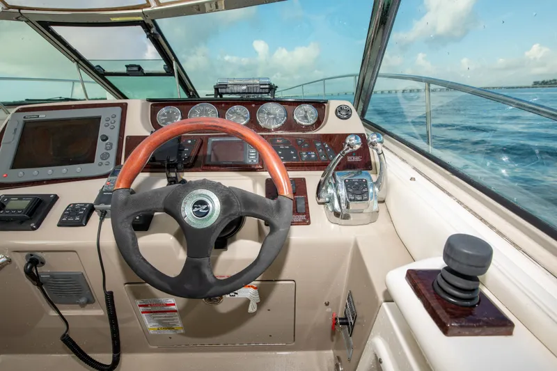 Slide: The Image of Helm of 2009 Sea Ray 350 Sundancer with steering wheel and navigation controls. - 26