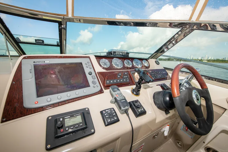 Slide: The Image of Helm of 2009 Sea Ray 350 Sundancer with navigation equipment and steering wheel. - 27