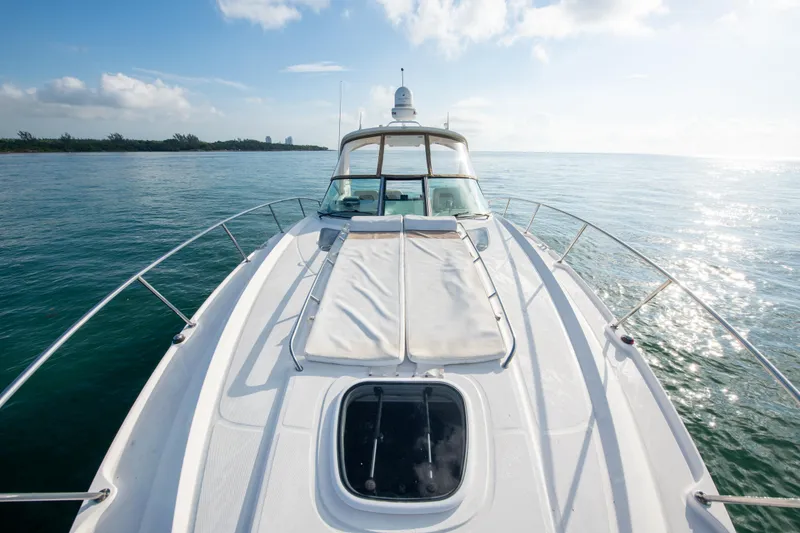 Slide: The Image of 2009 Sea Ray 350 Sundancer yacht on calm waters under a clear sky. - 33