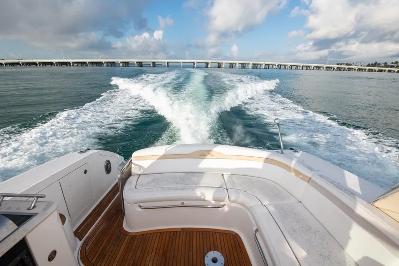 Slide: The Image of 2009 Sea Ray 350 Sundancer cruising on open water, view from the stern. - 4