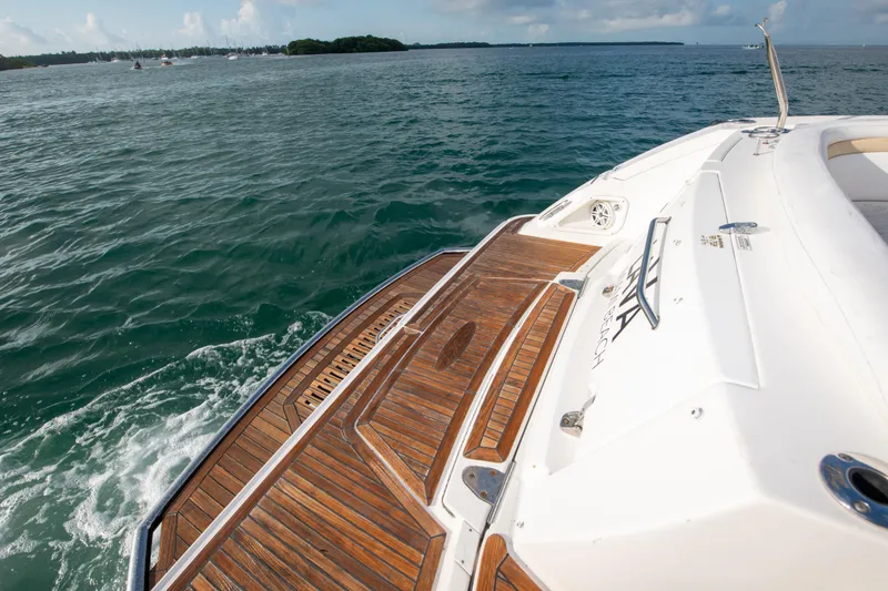 Slide: The Image of 2009 Sea Ray 350 Sundancer boat with teak swim platform on open water. - 43