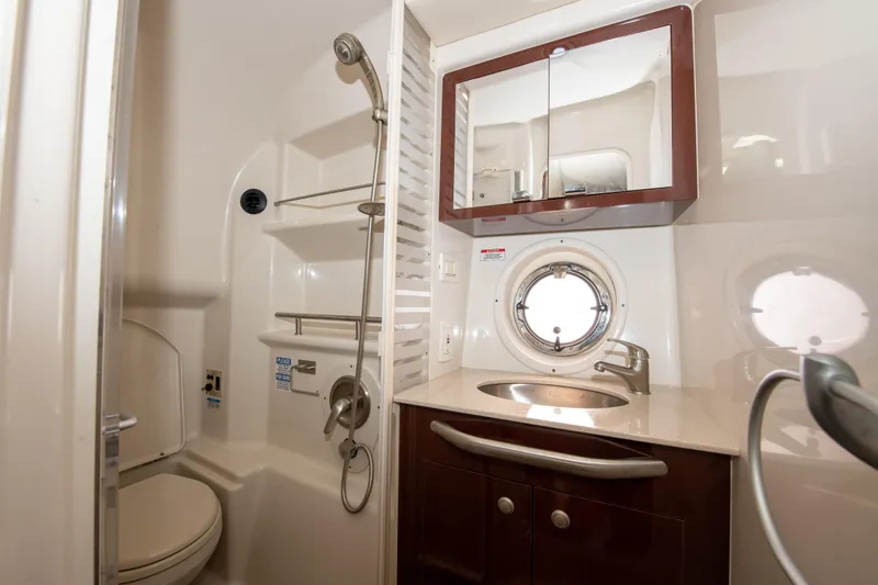 Slide: The Image of 2009 Sea Ray 350 Sundancer bathroom with shower, sink, and porthole window. - 9