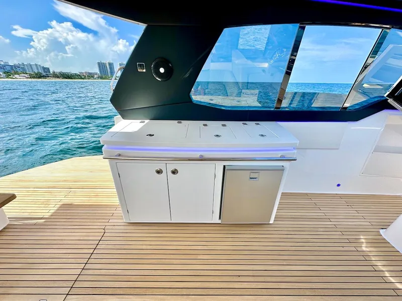 Slide: The Image of Schaefer 375 yacht 2025 model, outdoor kitchen area with ocean view. - 12