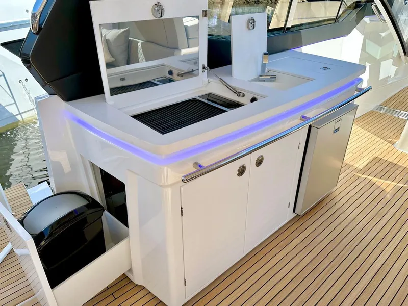Slide: The Image of Modern outdoor kitchen on a 2025 Schaefer 375 yacht with grill, sink, and mini-fridge. - 18