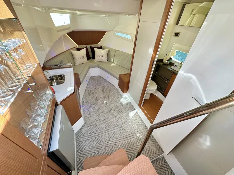 Slide: The Image of Luxurious interior of 2025 Schaefer 375 yacht with kitchenette, seating area, and bathroom. - 22