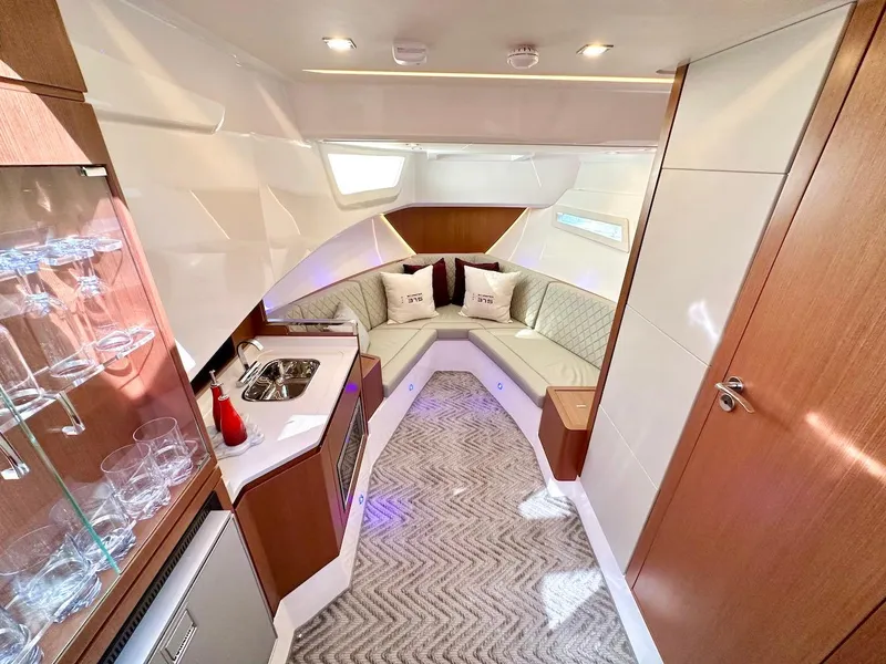 Slide: The Image of Luxurious interior of 2025 Schaefer 375 yacht with modern kitchenette and cozy seating area. - 24