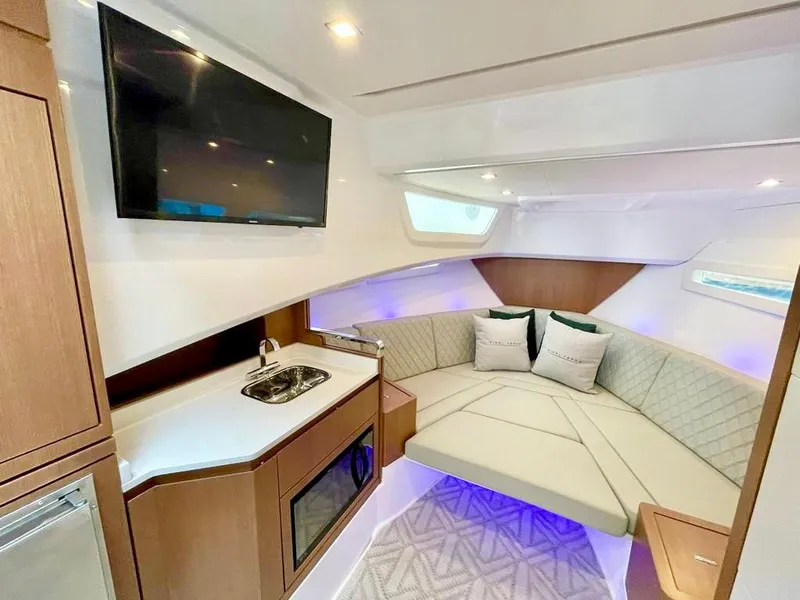 Slide: The Image of Interior of 2025 Schaefer 375 yacht with modern seating, kitchenette, and TV. - 27