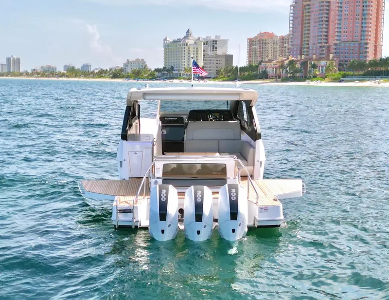 Slide: The Image of Schaefer 375 yacht 2025 model with triple 300 HP engines on the water near a city skyline. - 4