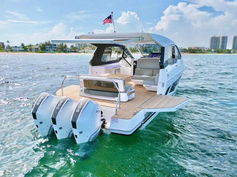 Slide: The Image of 2025 Schaefer 375 boat with triple outboard engines on clear water. - 7