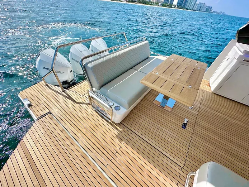 Slide: The Image of Luxury Schaefer 375 yacht deck with seating and table, powered by Mercury engines, 2025 model. - 10