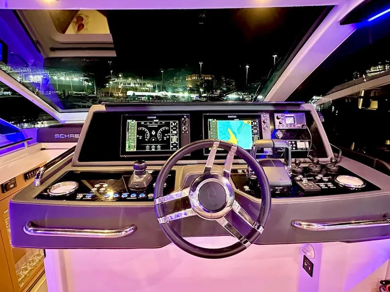 Slide: The Image of 2025 Schaefer 375 yacht cockpit with advanced navigation systems at night. - 19