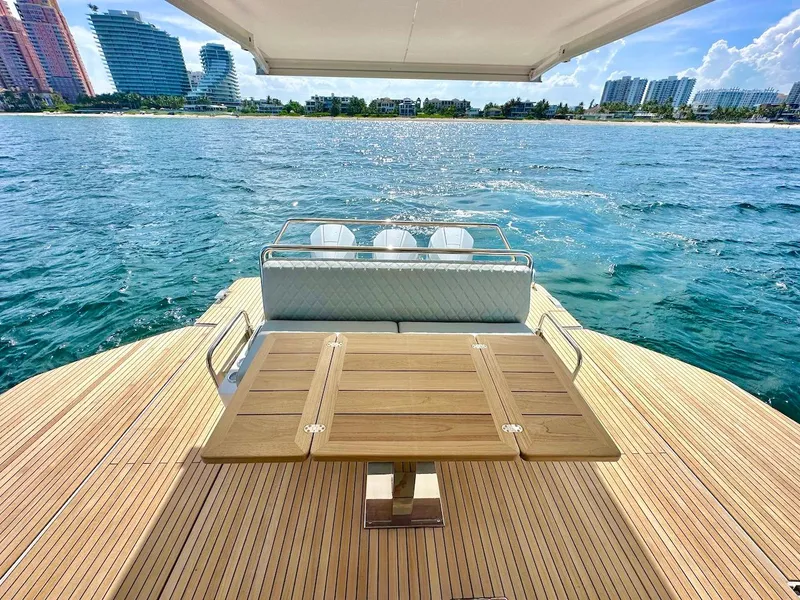 Slide: The Image of Schaefer 375 yacht 2025 model, rear deck view with ocean and cityscape background. - 9