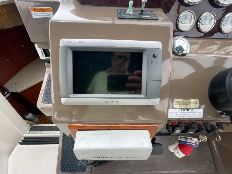 Slide: The Image of 2006 Regal 3060 Window Express dashboard with Garmin GPS and control panel. - 10