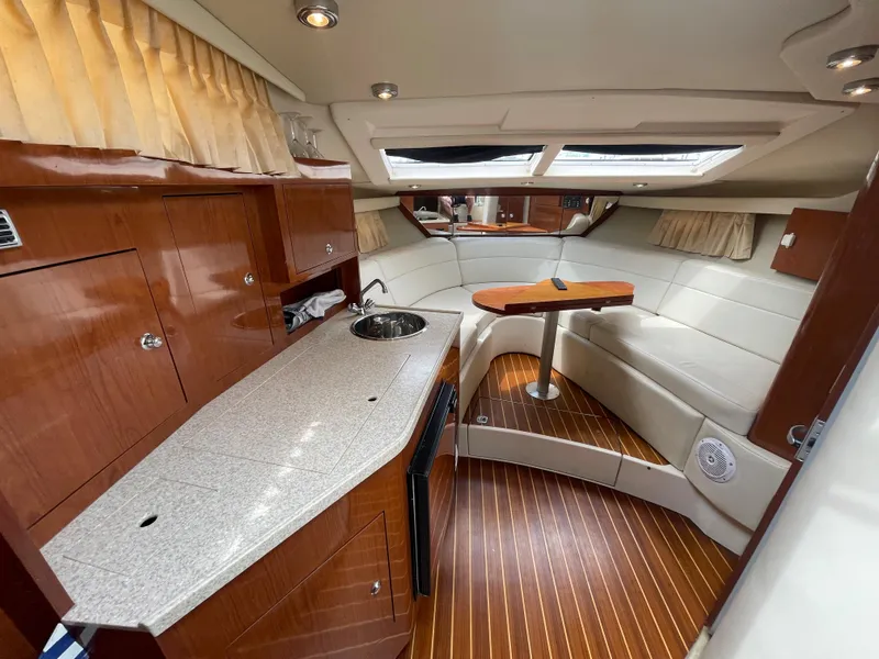 Slide: The Image of 2006 Regal 3060 Window Express yacht interior with kitchenette and seating area. - 15