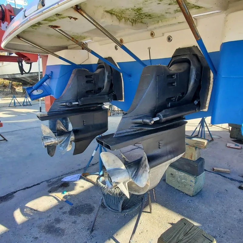 Slide: The Image of 2006 Regal 3060 Window Express boat outdrives in dry dock for maintenance. - 2