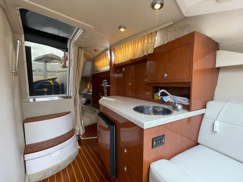 Slide: The Image of Interior of 2006 Regal 3060 Window Express yacht with kitchenette and seating area. - 21